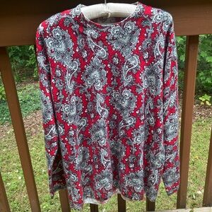 Kim Rogers red sweater with black and grey paisley